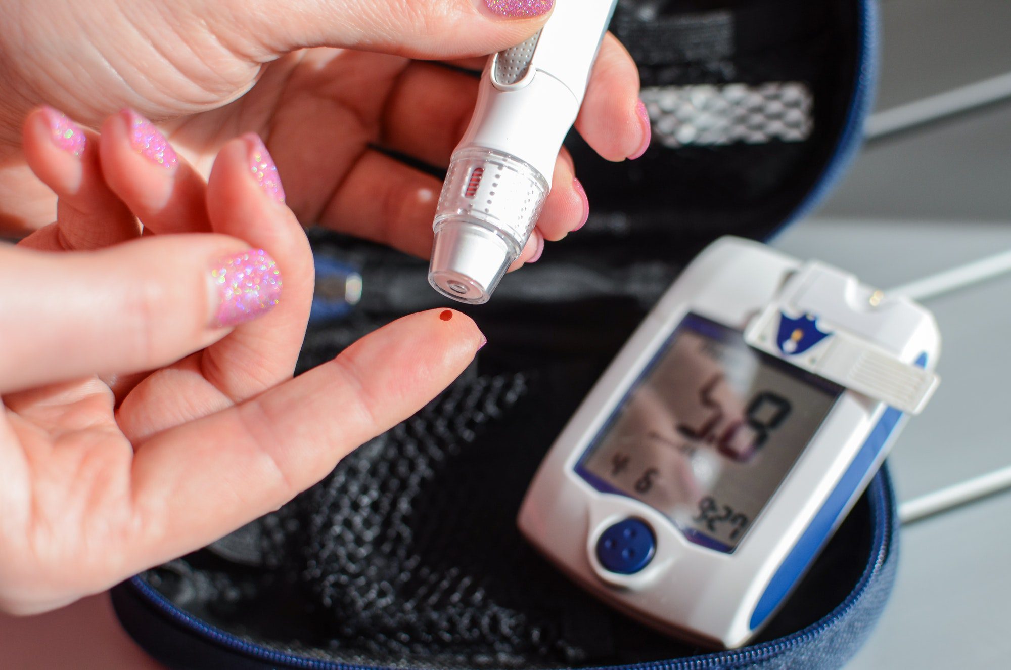 Medicare and Diabetic Supplies showing a Blood glucose meter pricking a finger.