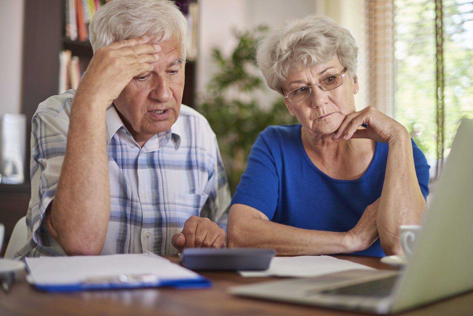 Couple sits and discusses problems with medicare cost and how Advantage plan could help.