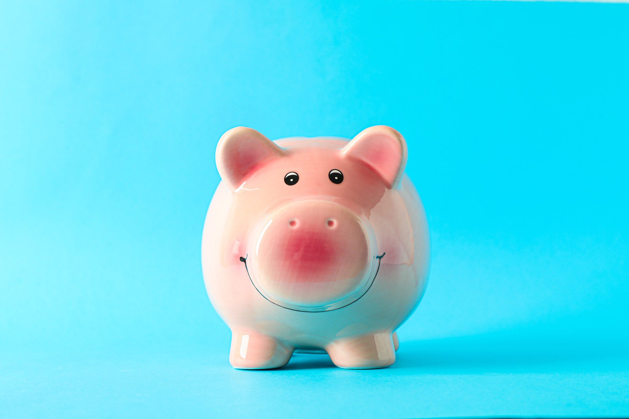 happy piggy bank on color background space for text finance saving money