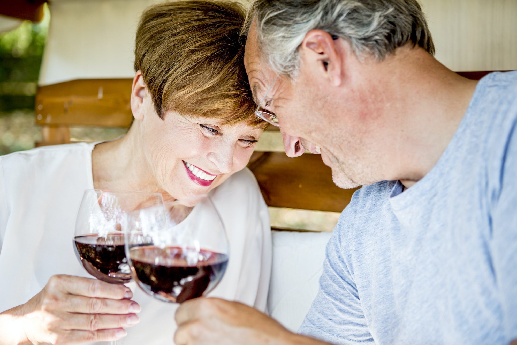 Happy senior couple enjoying a glass of wine as they discuss Medicare Part F and G