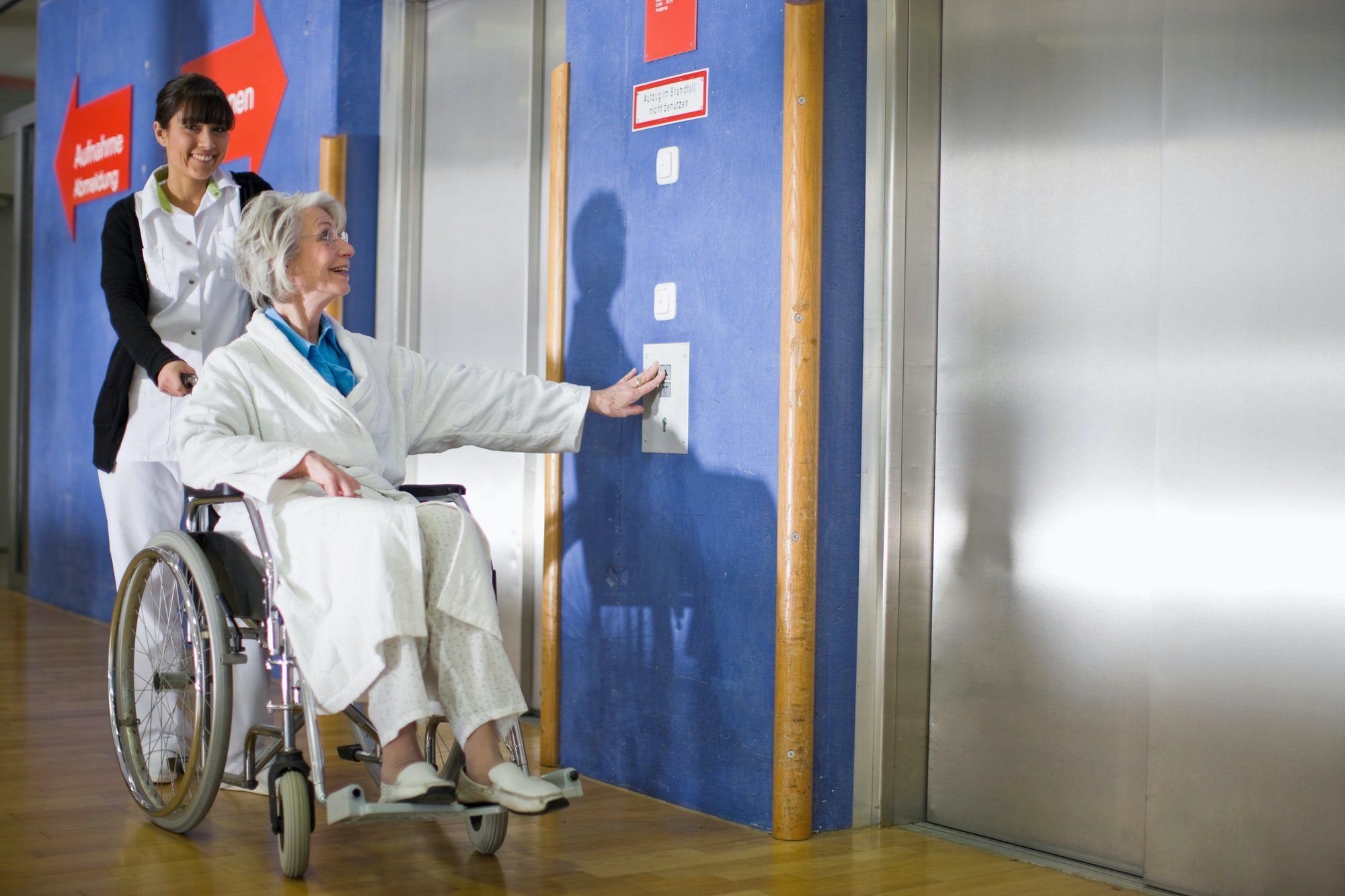 old woman in a wheel chair and nurse