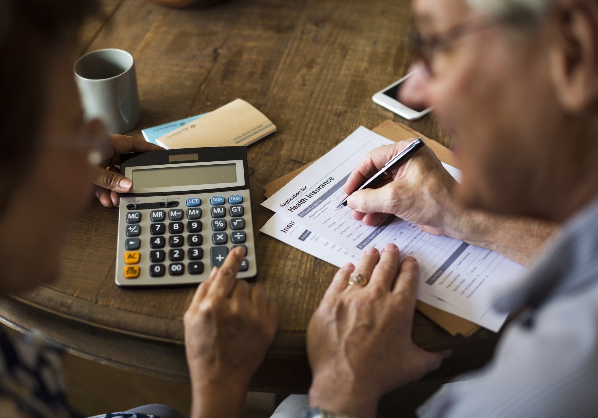 Senior couple filling out a medicare claim form.