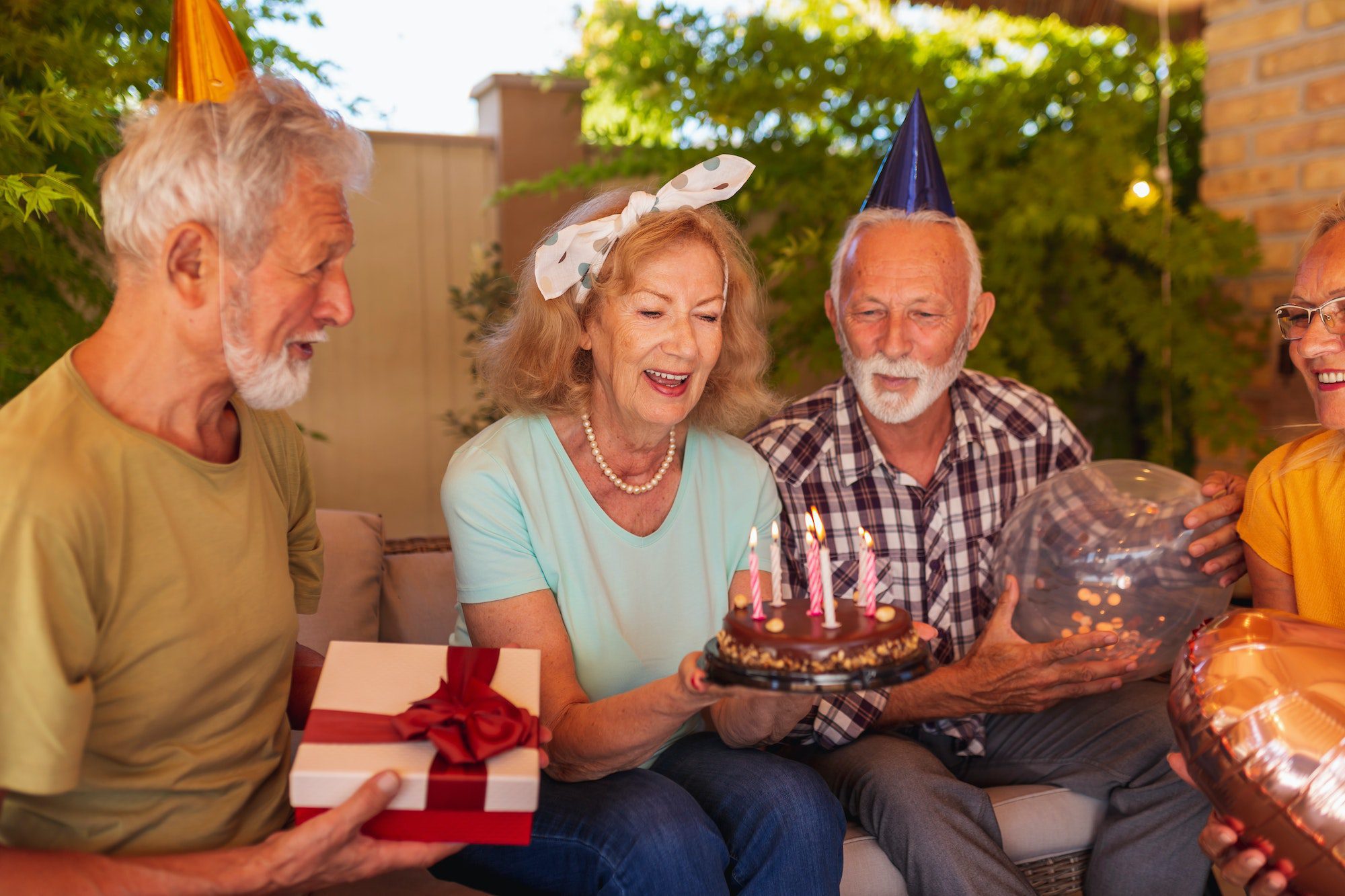 Elderly people blowing out candles on birthday cake knowing they have the perfect Medicare Supplement from Wyoming
