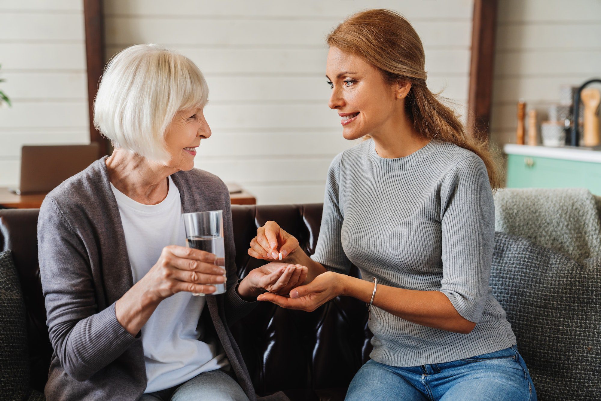 Senior woman taking pills from her daughter with Medicare Part D