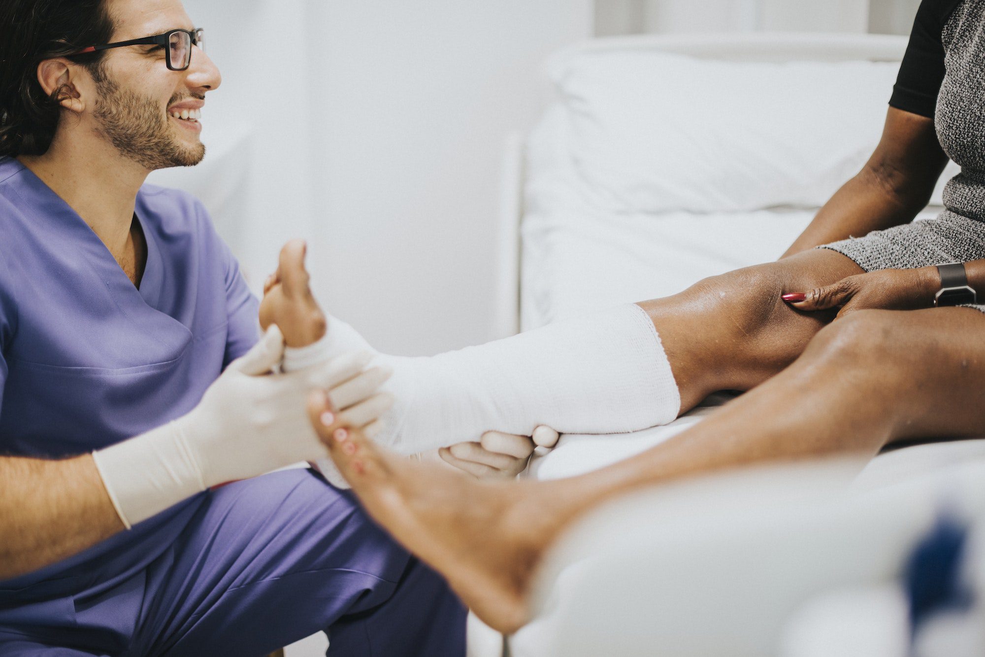 Podiatry Doctor helping a patient with a fractured leg with Medicare