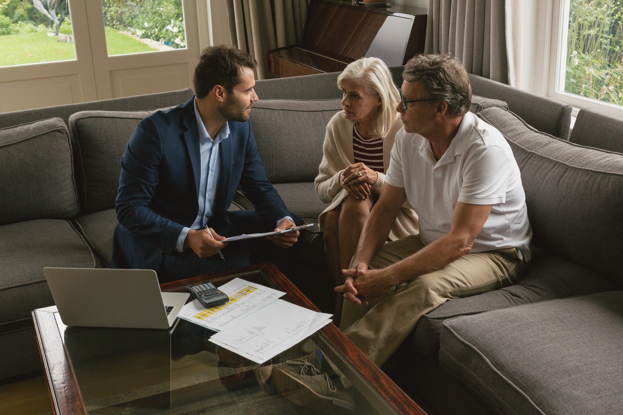 High view of active senior couple meeting with Medicare Advisor